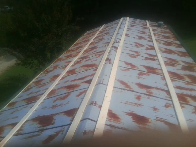 Rusted metal roof panels with new wood purlins before replacement — Storm Damage Roof Repair in Loma Mar by Roofing Brothers
